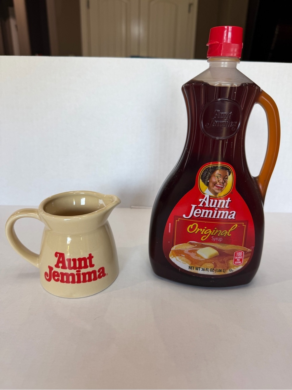 Cream and Red Ceramic Syrup Pitcher